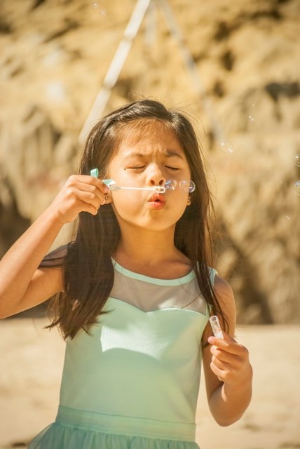 blowing bubbles beach wedding