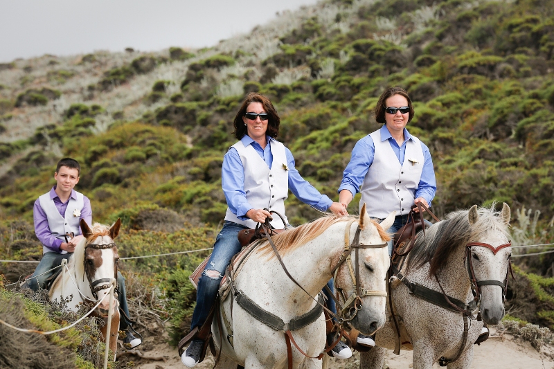 married on horseback on the beach