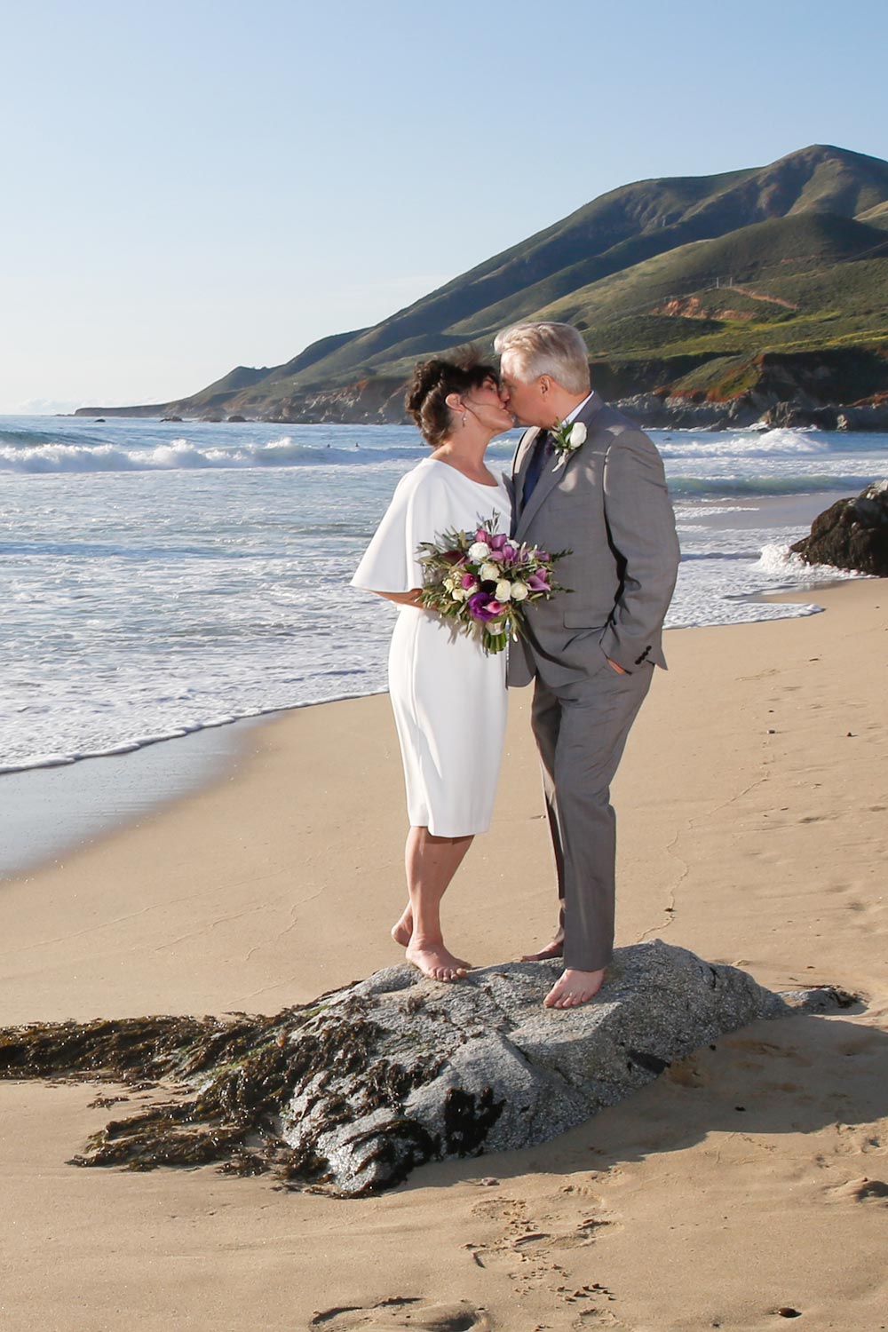 eloping couple kissing on the beach in California