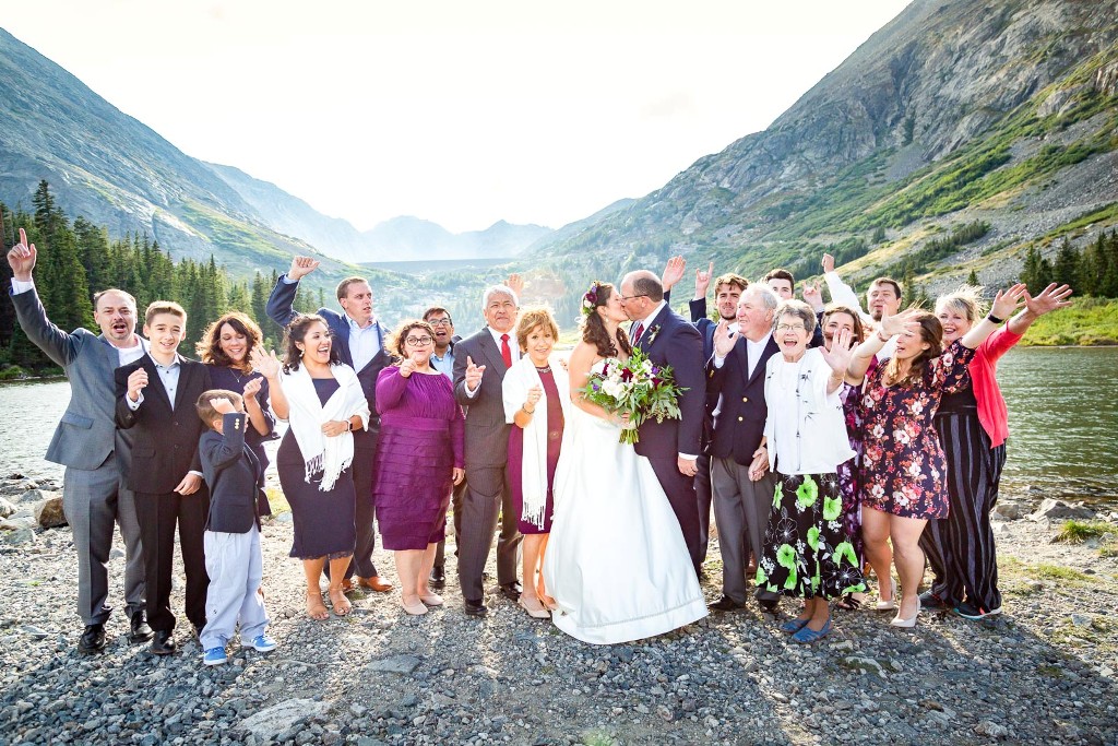 wedding guests by an alpine lake