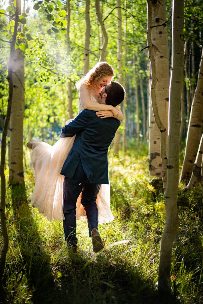 couple, composed by man and woman, hugging in the middle of a forest