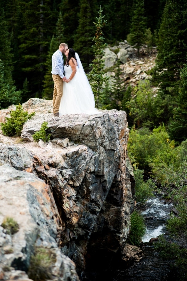 bride and groom standing on the cliffs