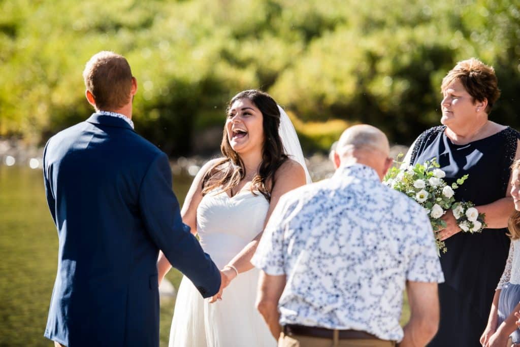 bride and groom laughing during ceremony