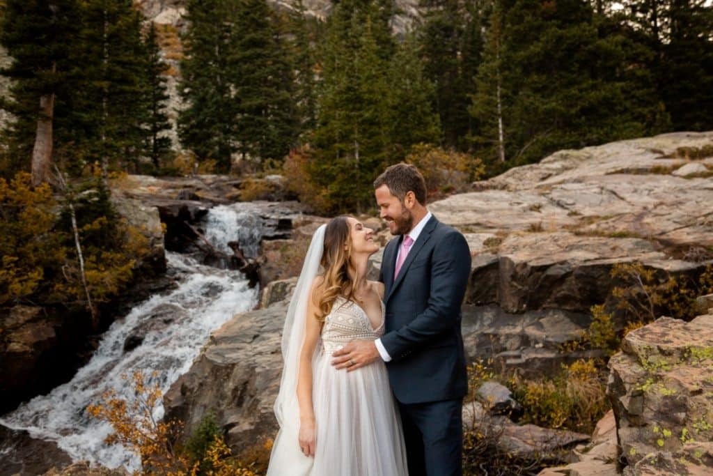 Justin and Annie in front of the waterfall in Breckenridge