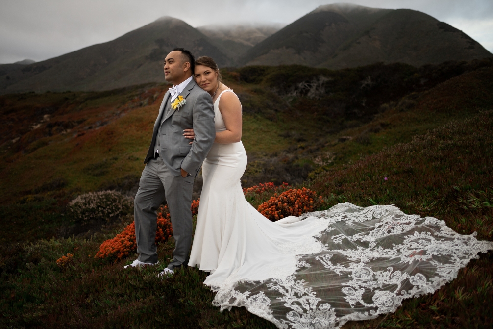 A couple on a misty hillside after purchasing an elopement package in California