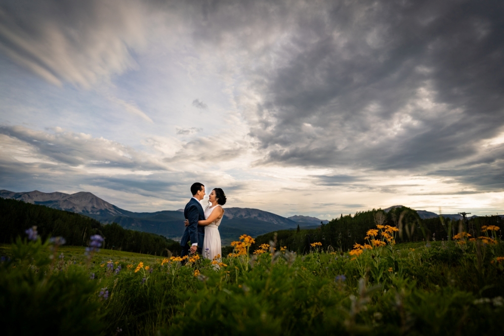 Couple standing amid wildflowers - eloping in Crested Butte