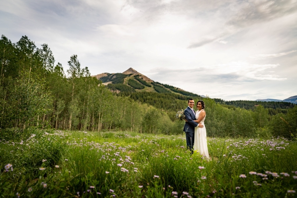 couple standing amid wildflowers