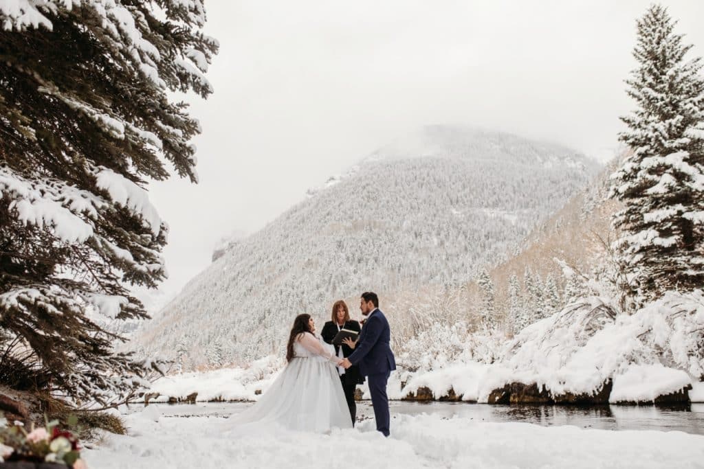 vows alongside the river in winter - Telluride elopement