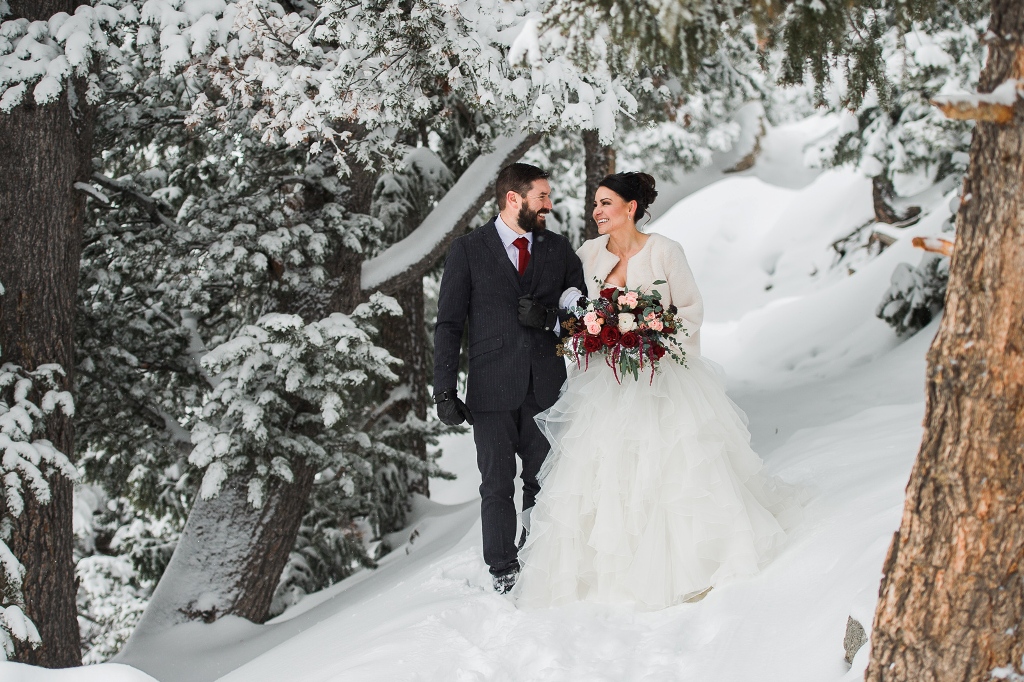 Newly eloped couple walking in the snow