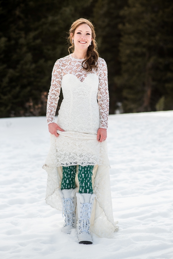 bride wearing boots and tights for a winter elopement in Colorado