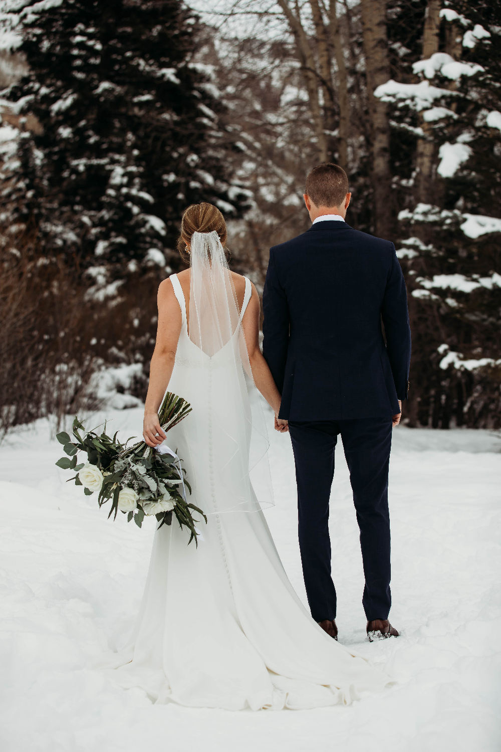 Newlyweds walking int the snow