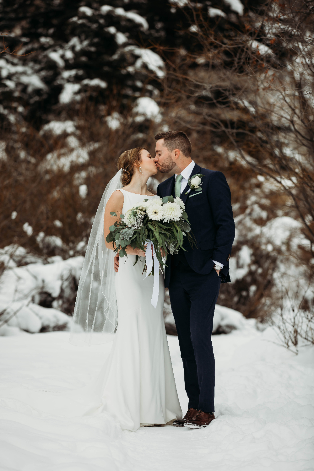 Winter-elopement. Newlyweds kissing